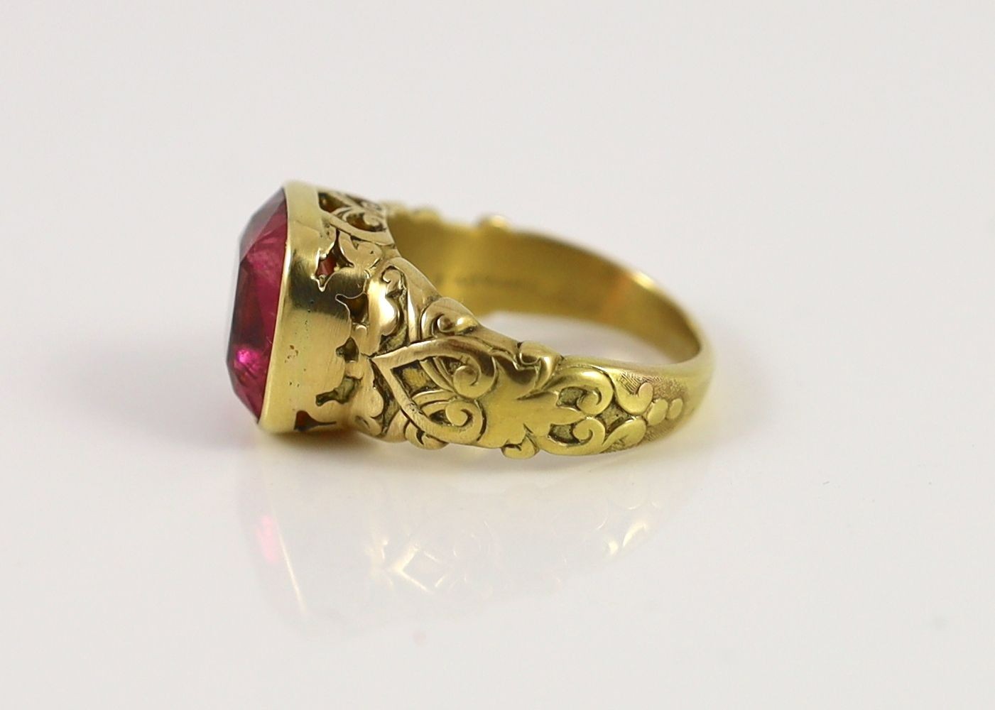 An antique Tiffany & Co gold and singe stone cushion cut rubellite set dress ring